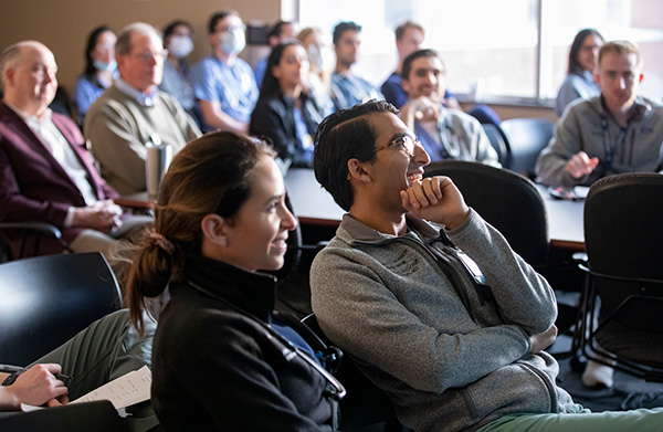 Vanderbilt residents react while listening to a classroom lecture.
