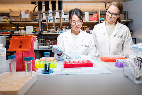 Two women research scientists work together in the lab.