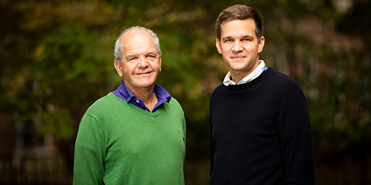 Drs. Roy Zent (left) and Fabian Bock (right), stand side by side in Vanderbilt's Chapman Quad with blurred trees in the background.