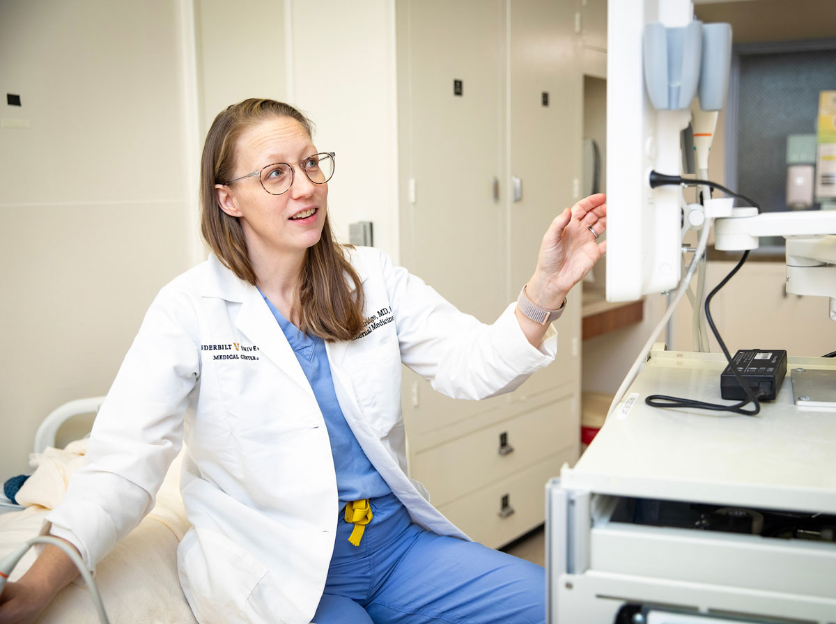 A female doctor looks at an untrasound screen in a clinic exam room.