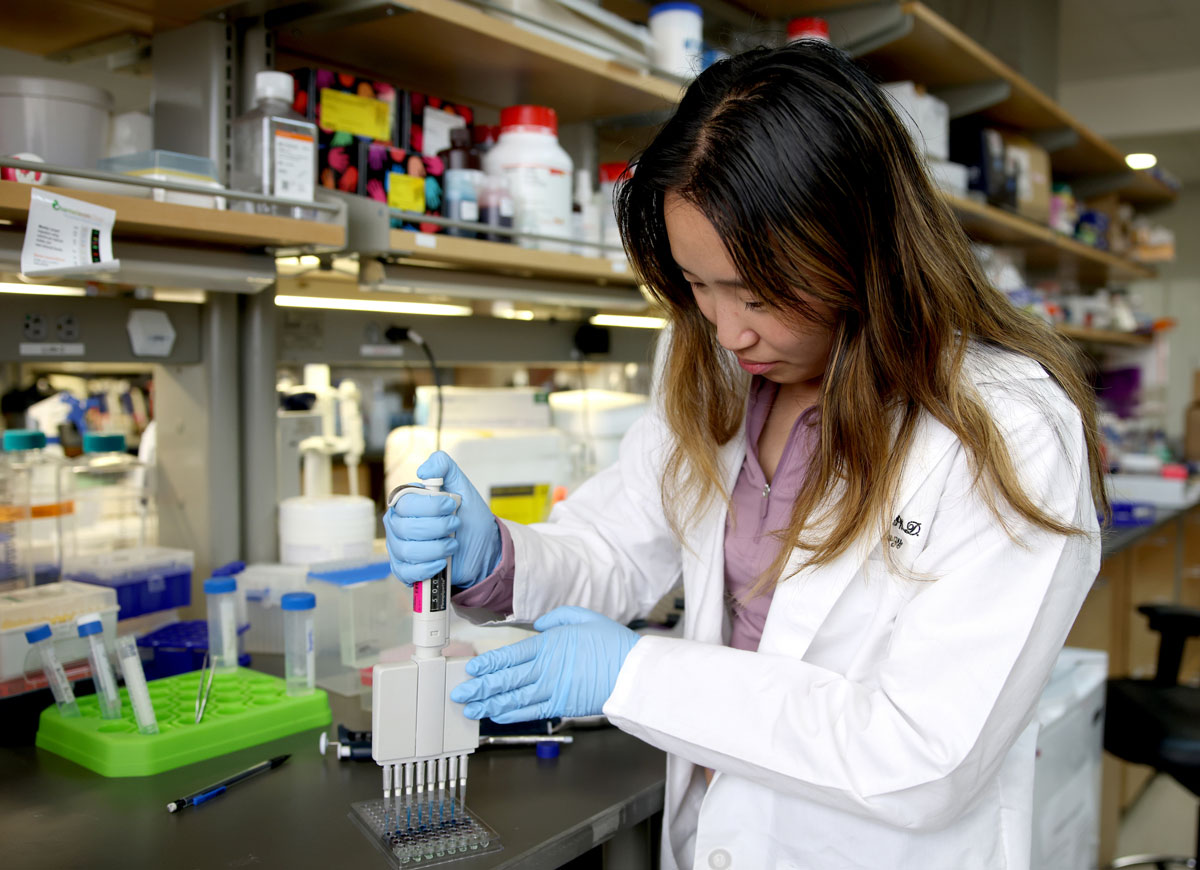 A young female research scientist works in the lab.