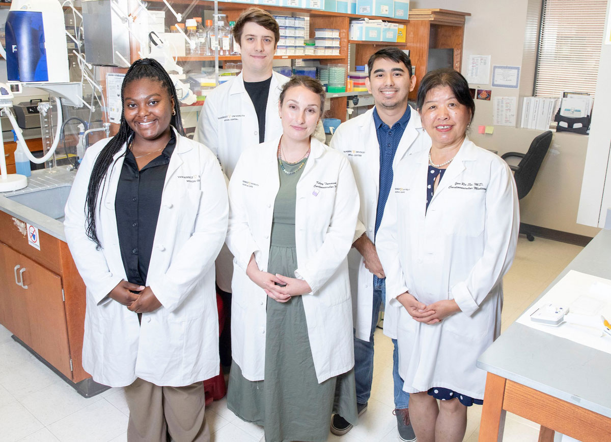 Five members of the cardiology core lab pose in their research lab.