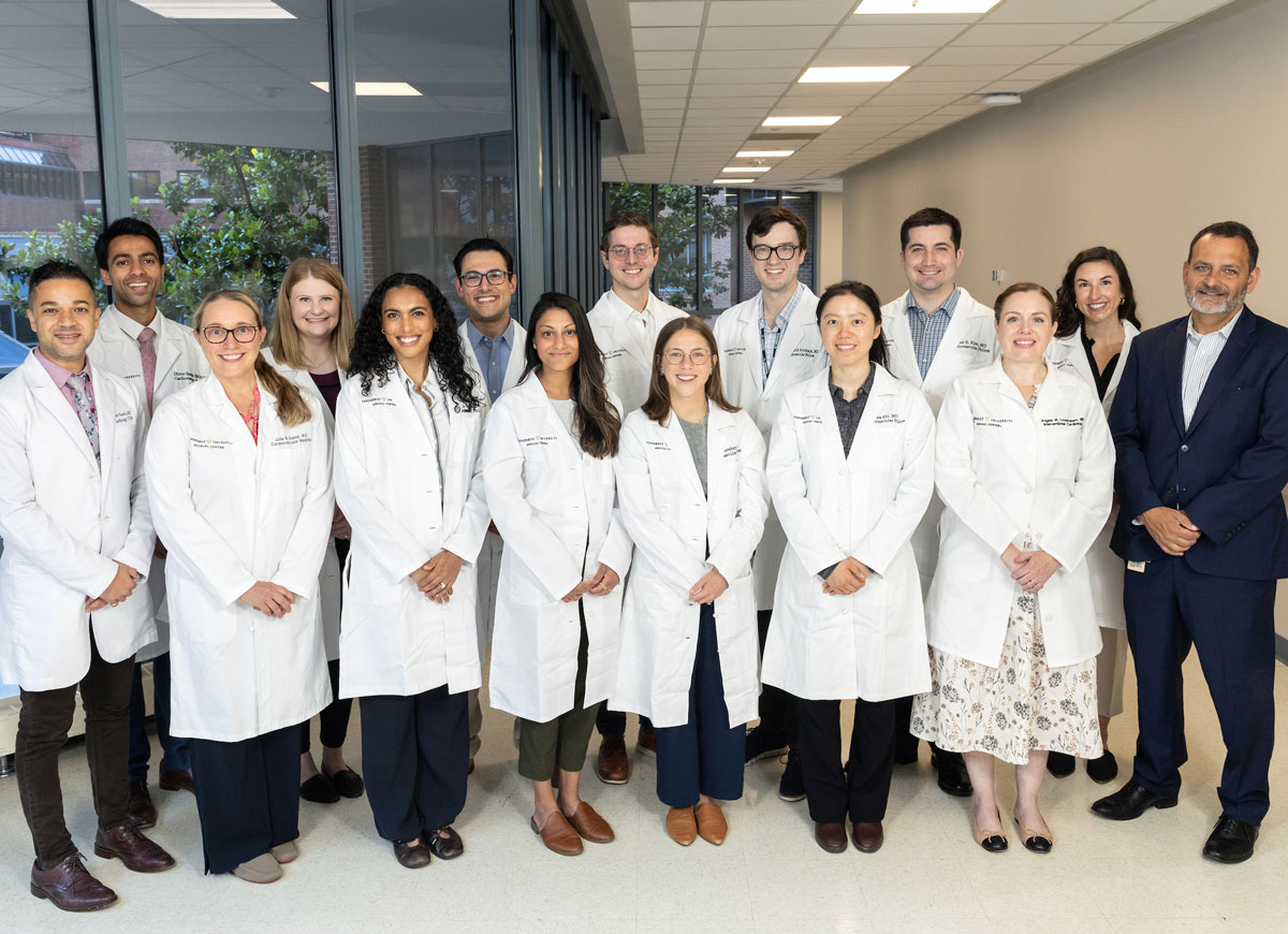 A group of 15 cardiology fellows and faculty mentors pose together.