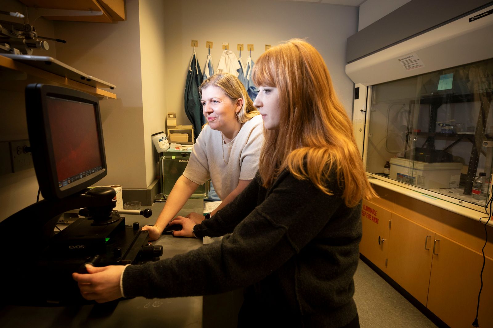 Two female research scientists work together in the lab.
