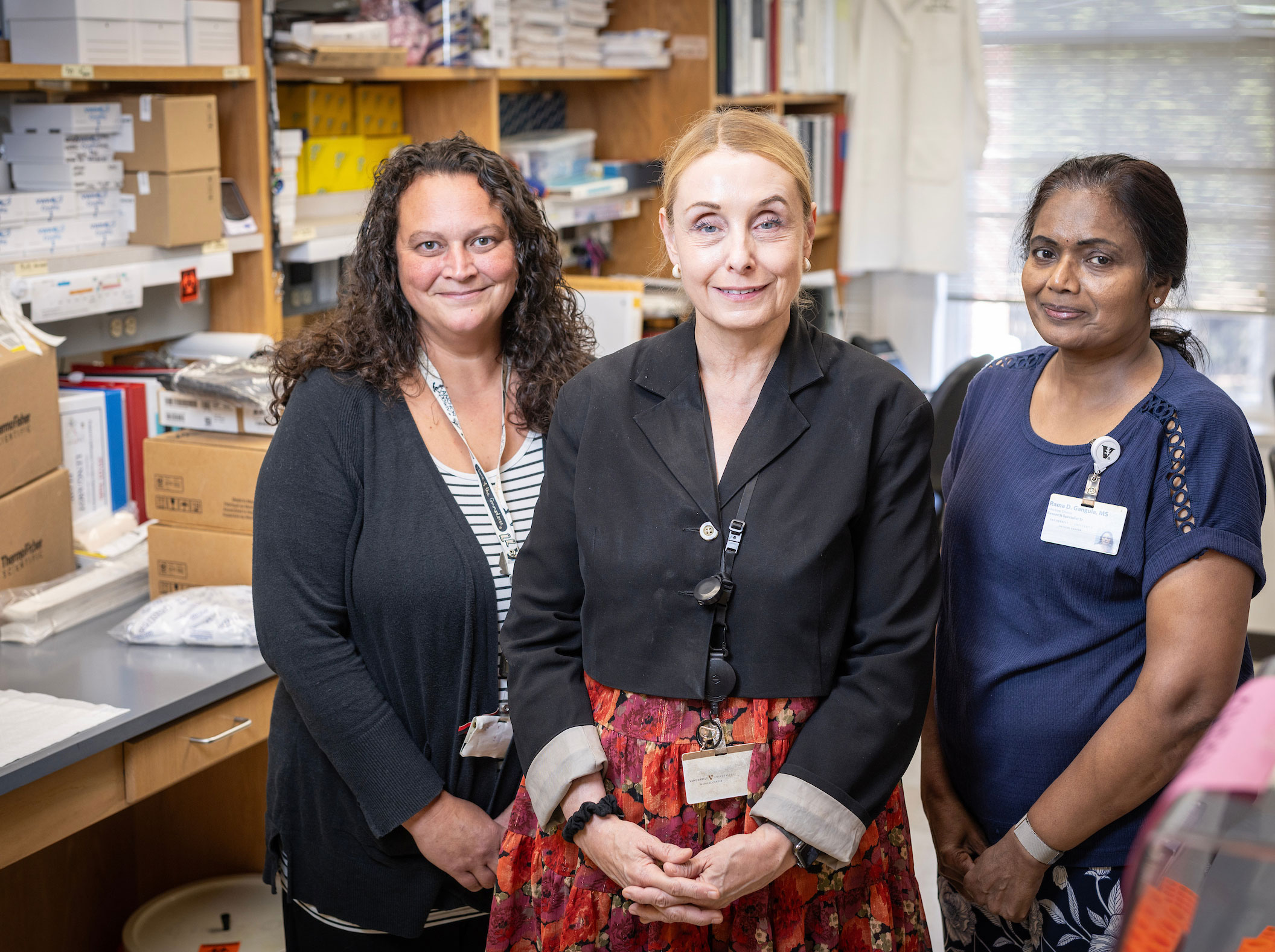 Dr. Elizabeth Phillips and two fellow researchers pose in the lab.