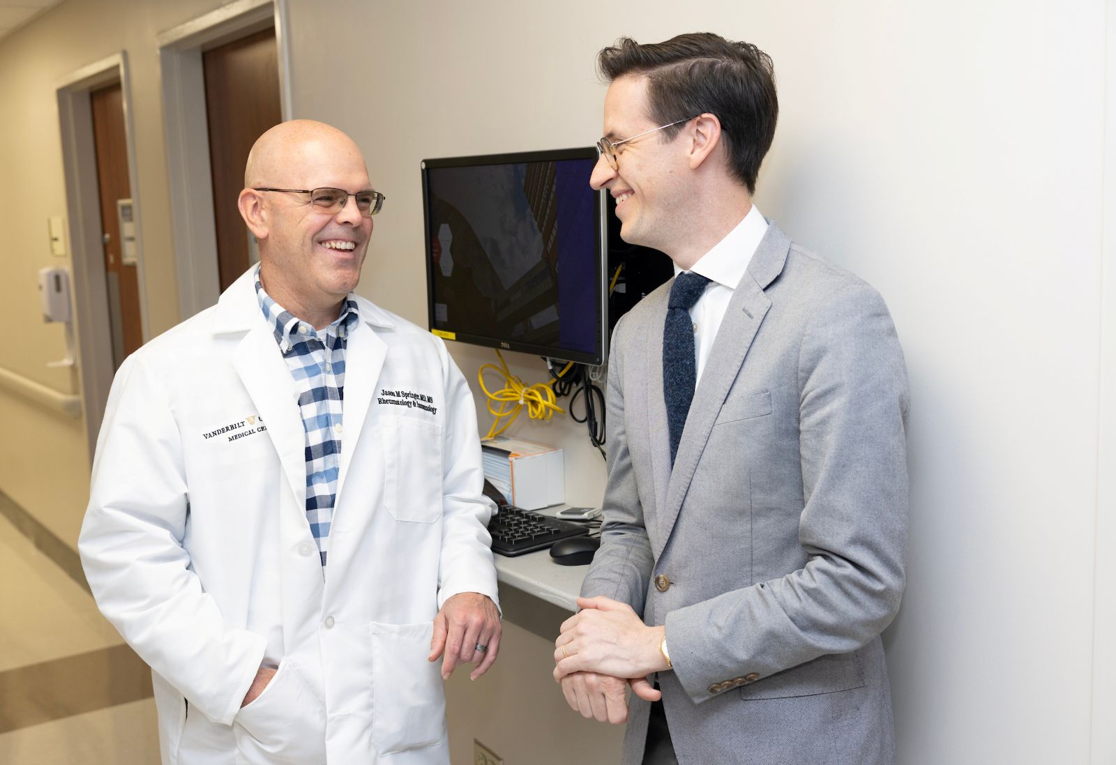 Schaffner Society advisor Dr. Jason Springer talks with a colleagues in a hospital hallway.