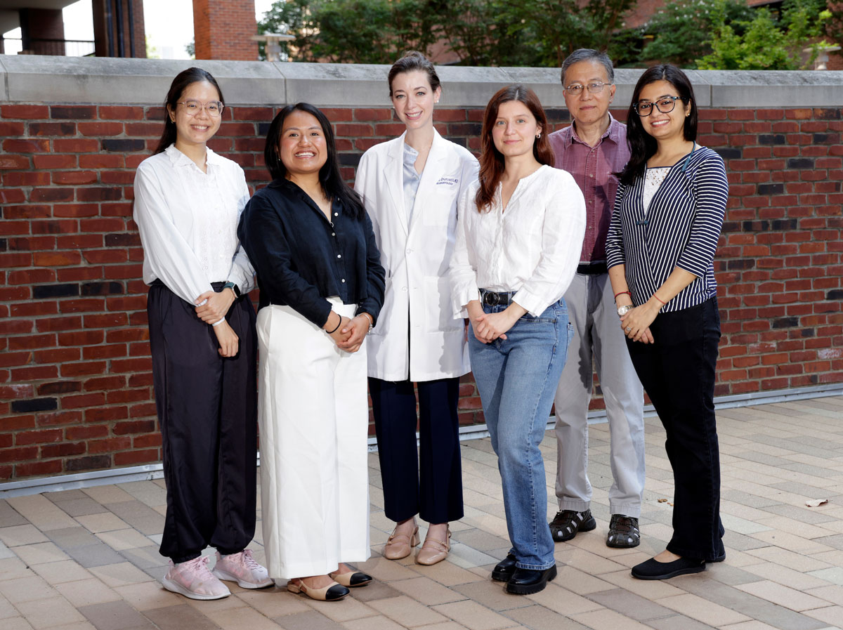 Six members of the Ormseth lab pose in an outdoor courtyard.